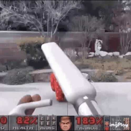 A Person Is Playing A Video Game With A Remote Control In Their Hands . GIF