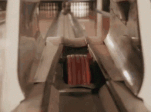 A Person Is Playing Bowling In A Bowling Alley With A Red Ball In The Middle . GIF