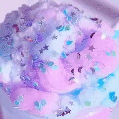a person is playing with a purple and blue slime .