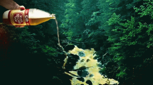A Person Is Pouring A Bottle Of Dr Pepper Into A Stream GIF