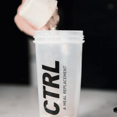 A Person Is Pouring Powder Into A Ctrl Meal Replacement Shaker GIF