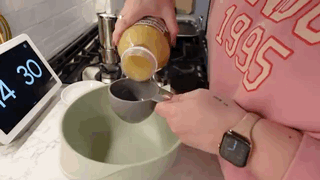 a person is pouring something into a bowl .