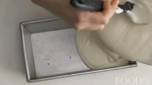 A Person Is Pouring Something Into A Pan With The Words Food52 Visible GIF