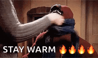 A Person Is Putting A Scarf Around Another Person 'S Neck With The Words `` Stay Warm '' Written Above Them . GIF