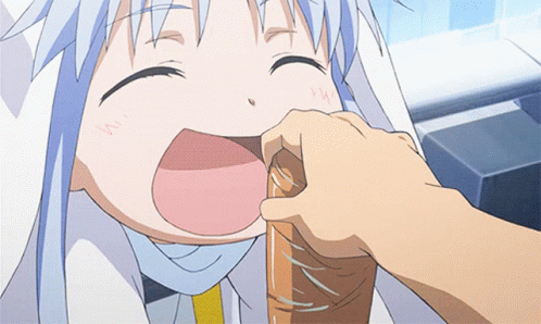 A Person Is Putting Something In A Child 'S Mouth With The Letter W On It GIF
