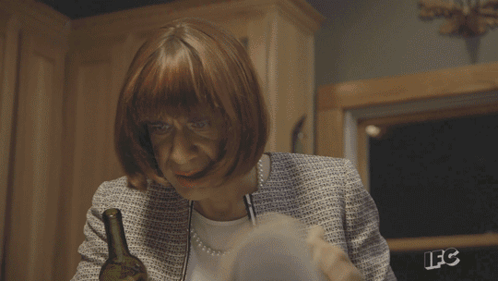 A Person Is Reading A Book With The Letters Lfc On The Back Of Their Jacket GIF