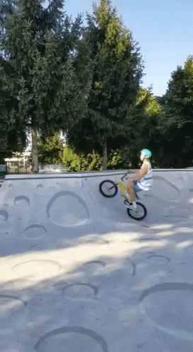 A Person Is Riding A Bike On A Ramp In A Skate Park GIF