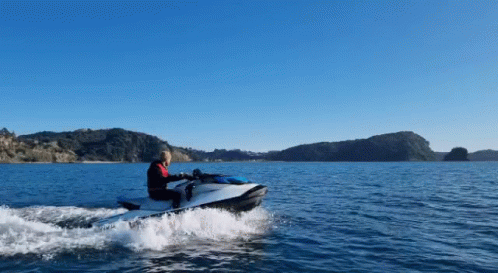 A Person Is Riding A Jet Ski In The Water GIF