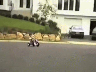 A Person Is Riding A Motorcycle Down A Street GIF