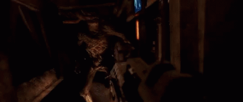 A Person Is Shooting A Gun In A Dark Room And There Is A Lot Of Smoke Coming Out Of The Gun . GIF