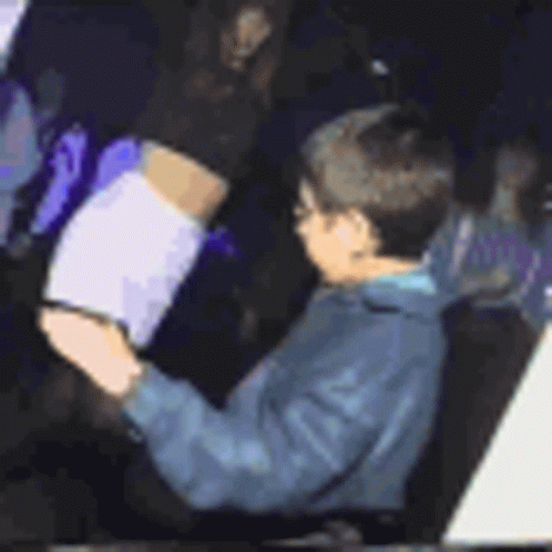 A Person Is Sitting In A Car Using A Tablet . GIF