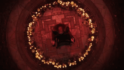 A Person Is Sitting In A Circle Of Lights GIF
