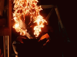 A Person Is Sitting In A Room With A Lot Of Fire Coming Out Of Their Body . GIF