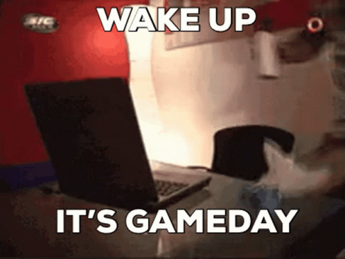 A Person Is Sitting In Front Of A Laptop With The Words Wake Up It 'S Gameday GIF