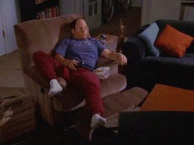 A Person Is Sitting On A Couch With A Shelf Full Of Sodas And Snacks Including A Can Of Dg GIF