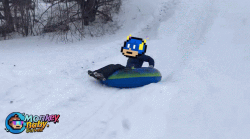A Person Is Sledding Down A Snowy Hill With Monkey Baby Written On The Bottom Of The Picture GIF