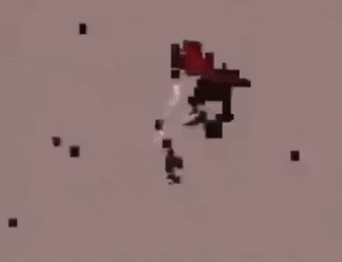 A Person Is Standing In A Dark Room With A Red Light Coming From The Ceiling . GIF