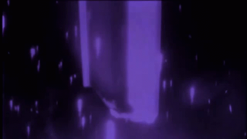A Person Is Standing In A Dark Room With Purple Lights Behind Them GIF