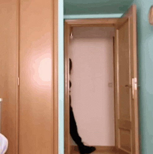 A Person Is Standing In A Doorway With Their Feet Visible GIF