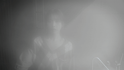 A Person Is Standing In A Foggy Room With The Letter N In The Foreground GIF