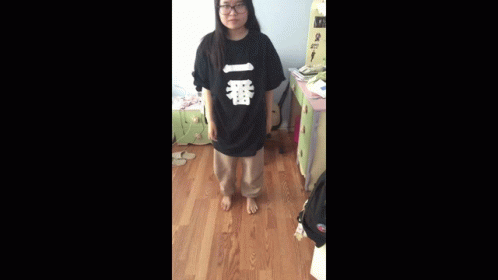 A Person Is Standing In A Room With A Sign That Says ' A ' On It GIF