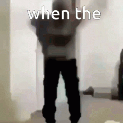 A Person Is Standing In A Room With Their Arms In The Air And The Words `` When The '' Written On The Bottom . GIF