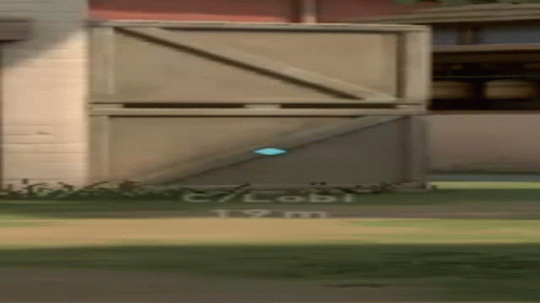 A Person Is Standing In Front Of A Building With A Blue Object In The Air . GIF