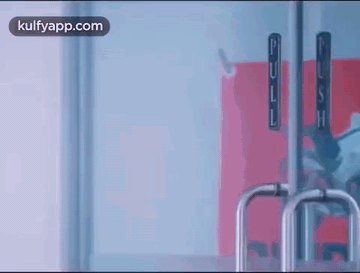 Person Standing In Front Of Glass Door With Handle GIF