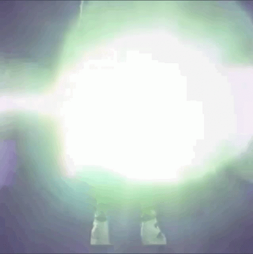 A Person Is Standing In Front Of A Glowing Light GIF