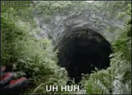 a person is standing in front of a hole in the ground with the words uh huh written on it .