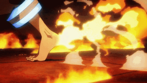 A Person Is Standing In Front Of A Large Fire GIF