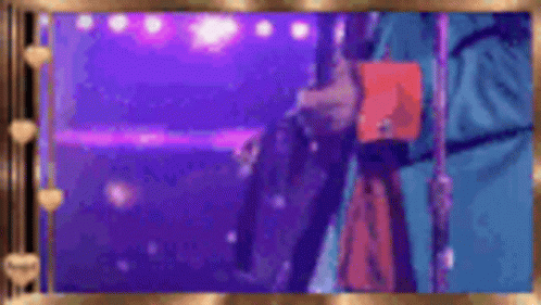 A Person Is Standing In Front Of A Microphone On A Stage Holding A Book . GIF