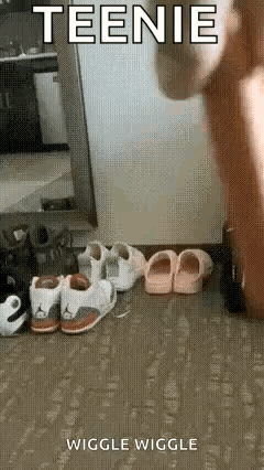 a person is standing in front of a mirror next to a row of shoes .