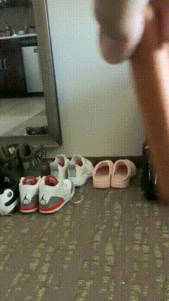 A Person Is Standing In Front Of A Mirror With A Bunch Of Shoes And Sandals On The Floor GIF