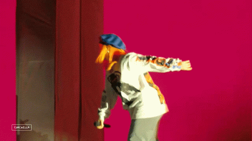A Person Is Standing In Front Of A Sign That Says Gazella GIF