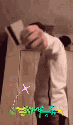 A Person Is Standing In Front Of A Wall With A Sticker That Says " N " On It GIF
