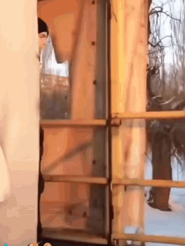 Person Standing In Front Of Wooden Door GIF