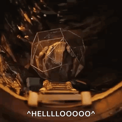 A Person Is Standing On A Staircase Next To A Rock In A Glass Cube With The Words Hellooooo Written Below It . GIF