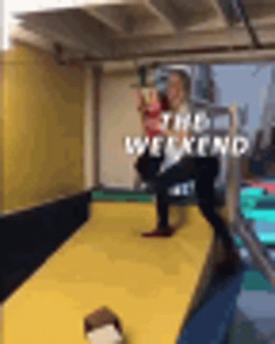 A Person Is Standing On A Yellow Mat In A Room With The Word Weekend Written On It . GIF