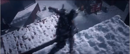 A Person Is Standing On Top Of A Snow Covered Concrete Block . GIF