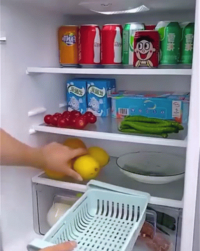 A Person Is Taking A Basket Out Of A Refrigerator Filled With Food And Drinks . GIF