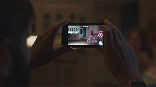 A Person Is Taking A Picture Of A Little Girl On A Phone GIF
