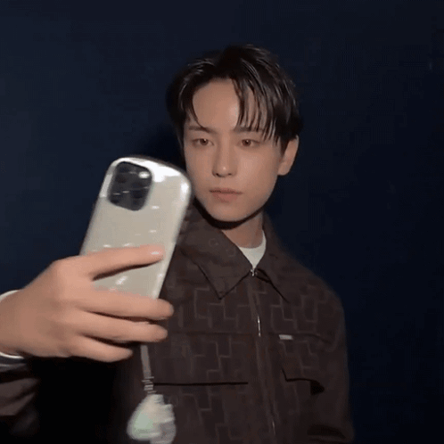 A Person Is Taking A Picture Of A Man With A Phone GIF