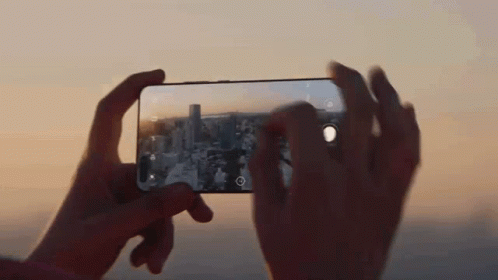 A Person Is Taking A Picture With A Cell Phone GIF