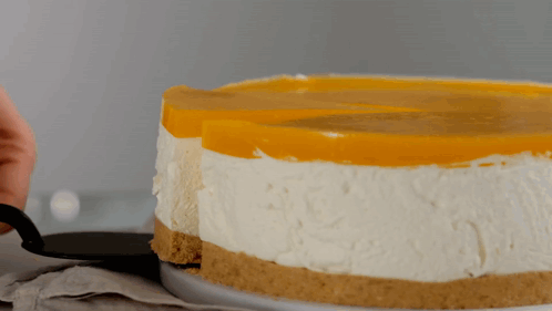 A Person Is Taking A Slice Of Cheesecake GIF