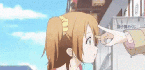 A Person Is Touching A Girl 'S Forehead With Their Finger While Standing In Front Of A Building . GIF