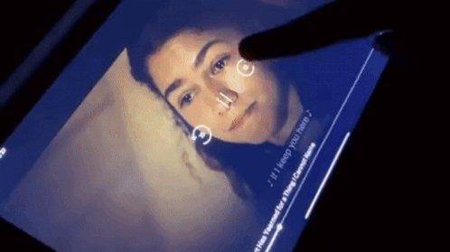 A Person Is Touching A Screen With A Picture Of A Woman And The Words " If I Keep You Here " On It GIF