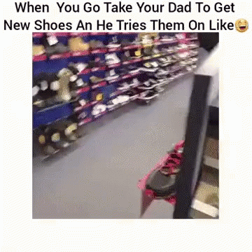 A Person Is Trying On A Pair Of Shoes In A Store . GIF