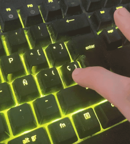 A Person Is Typing On A Keyboard With The Enter Key Visible GIF