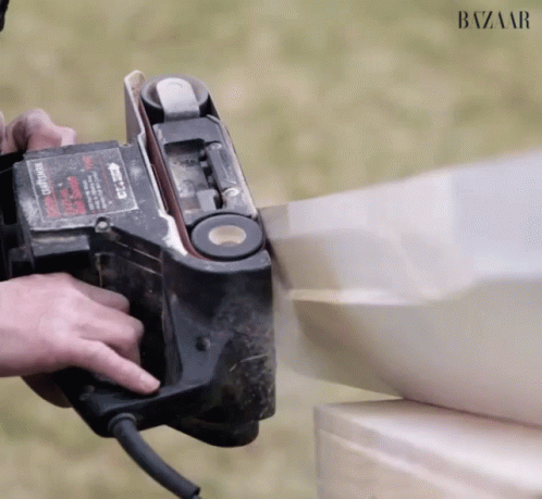 A Person Is Using A Belt Sander Which Says Craftsman On It GIF